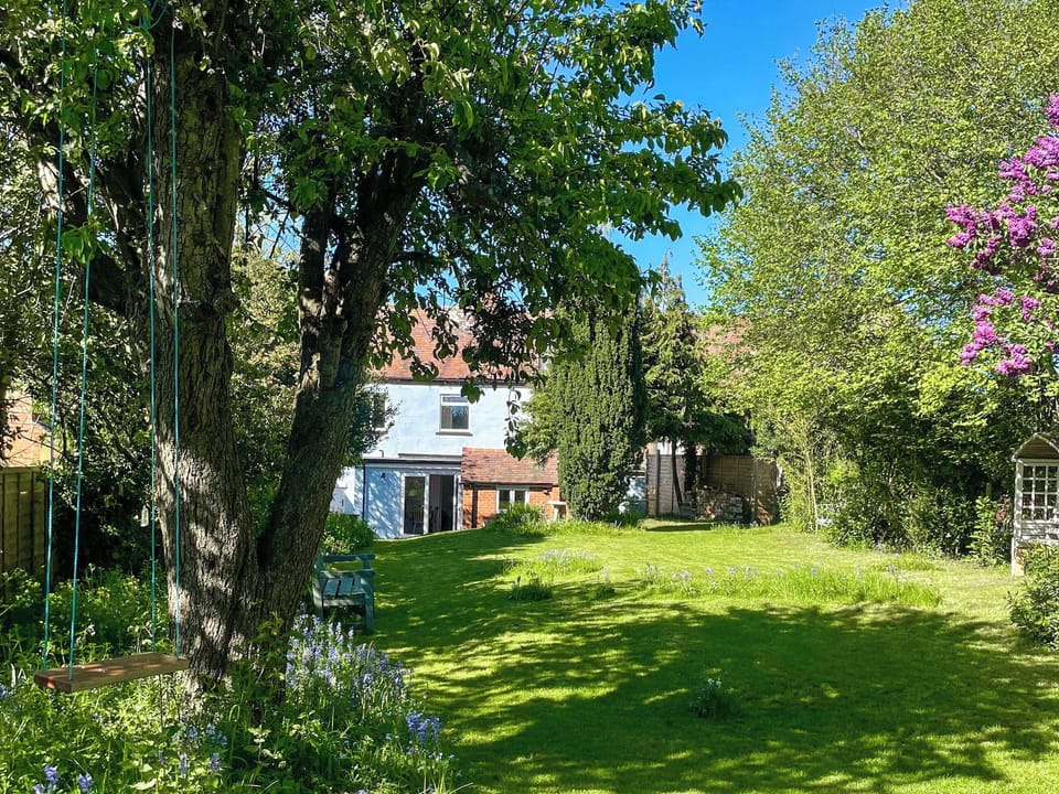 Relax on the tree swing in the enclosed private garden. | Amphlett Cottage, Bredon, near Tewkesbury