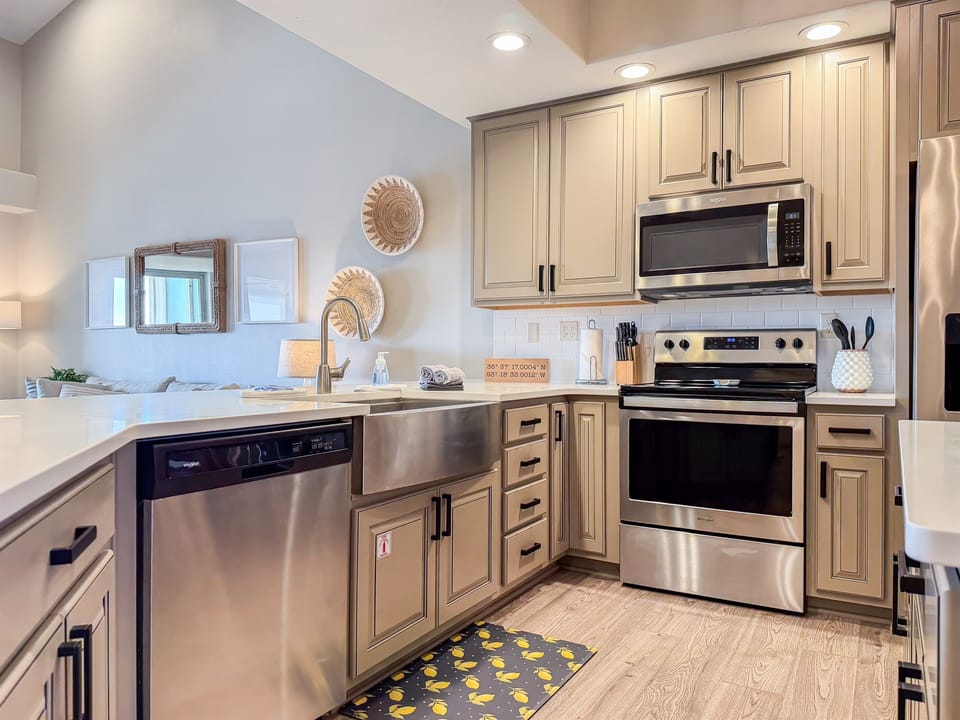 Kitchen with dishwasher, stove, microwave, and fridge