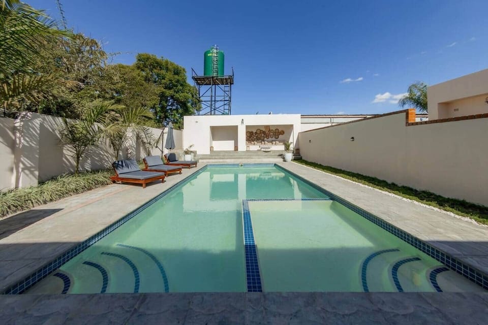 Outdoor swimming pool with sun loungers