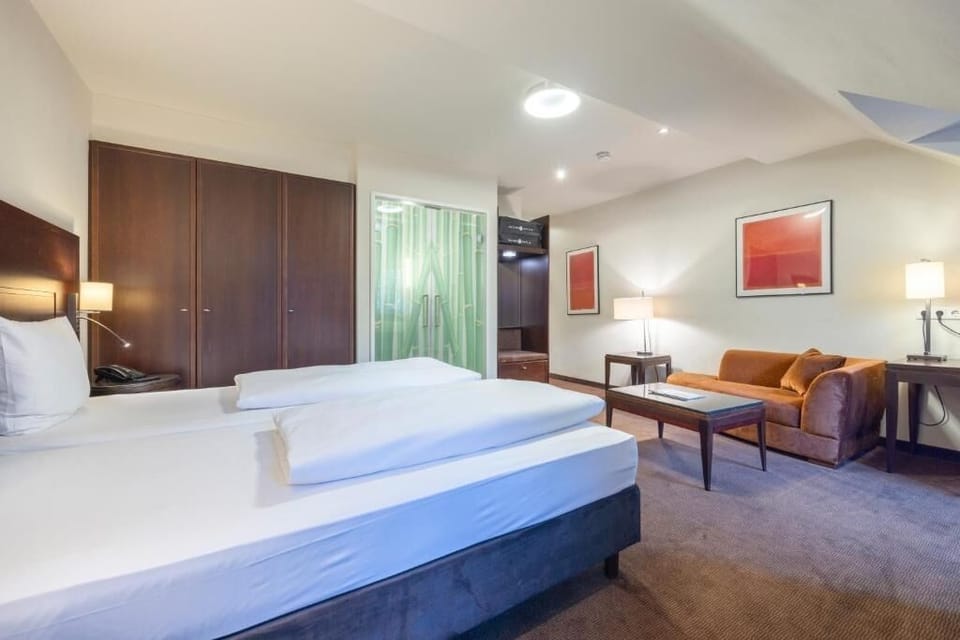 Lounge comfortably after exploring, with sofa seating beside the bed.