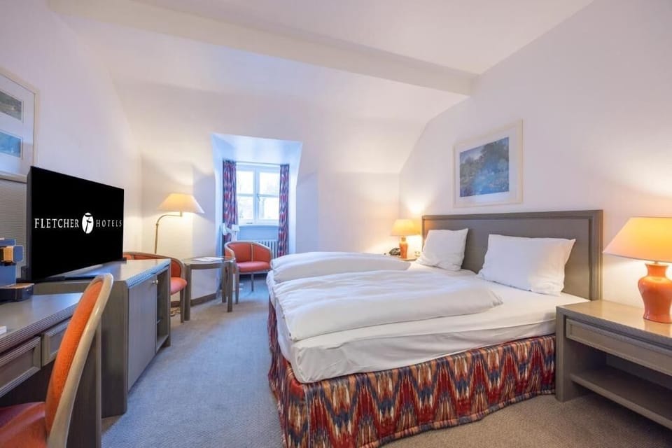 Sink into plush bedding in a calm, warmly lit retreat.