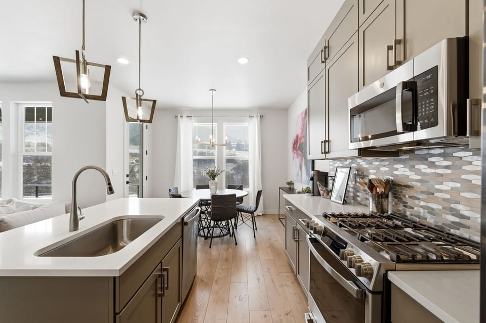 Cook, dine, and spend time together in this open kitchen and dining area.