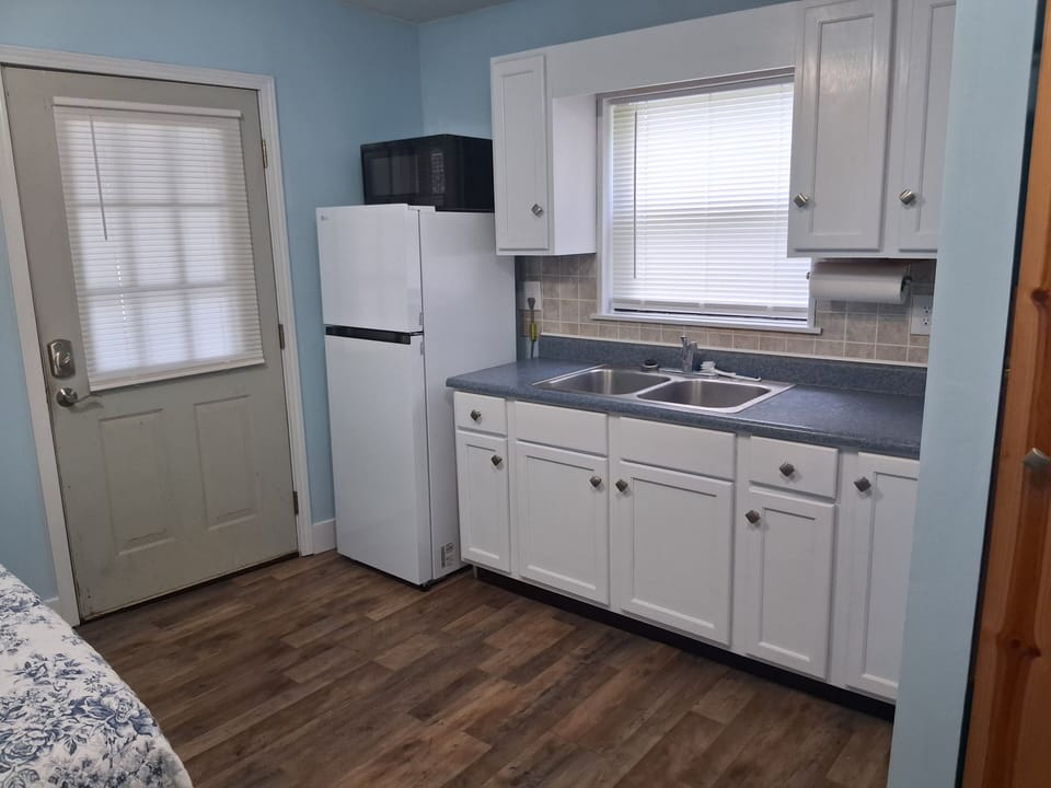 microwave, kitchenette, refrigerator, coffee maker, air fryer.