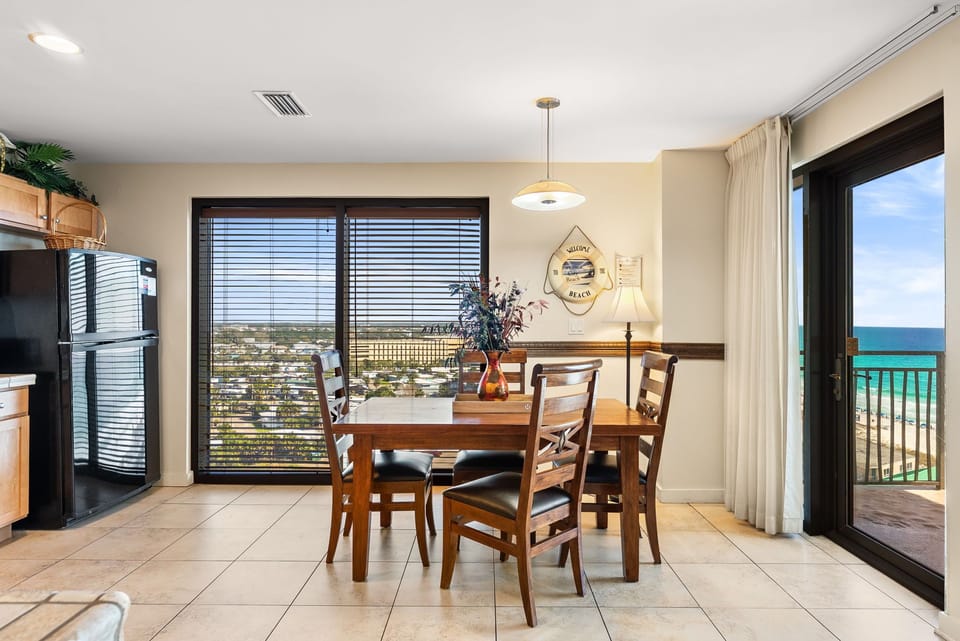 Savor meals with stunning ocean views through your dining room's floor-to-ceiling windows, where beach breezes flow from the private balcony.