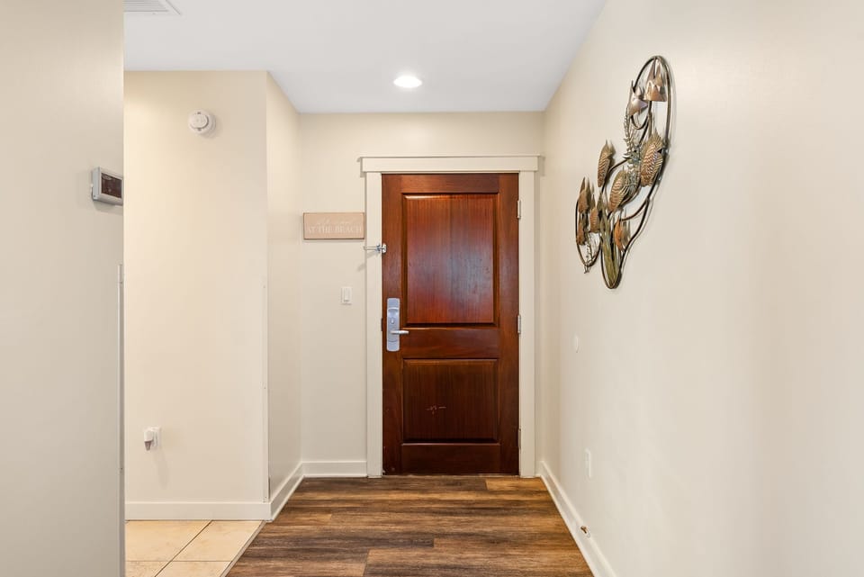 Step into your welcoming entryway, where warm wood floors and elegant decor create an inviting first impression of your home away from home.