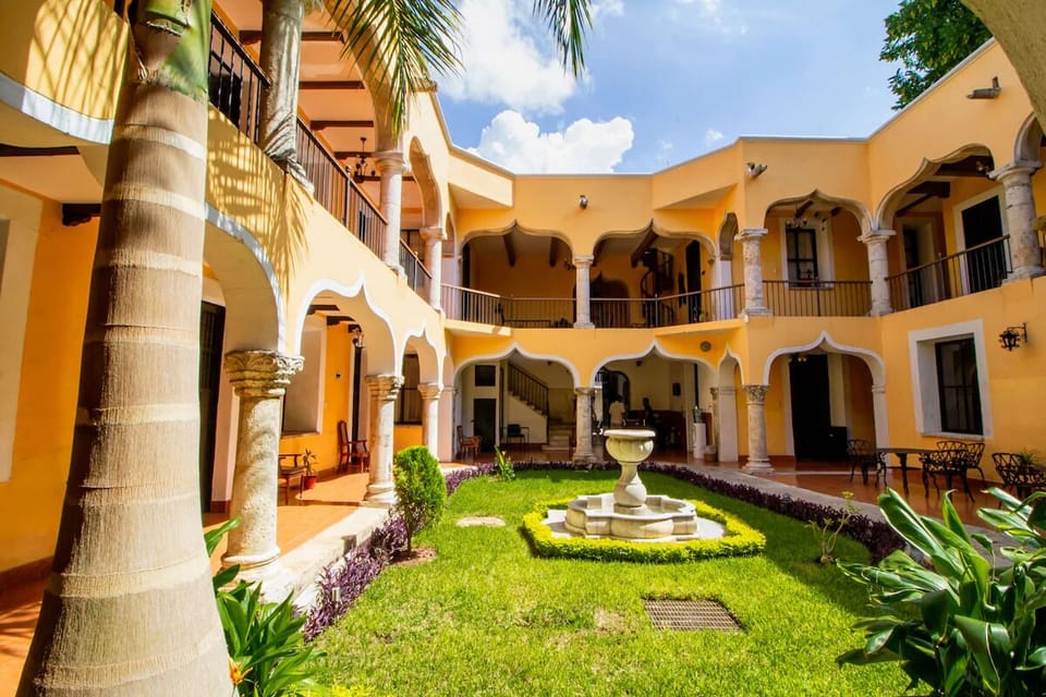 Step into a sun-drenched courtyard oasis with central fountain.