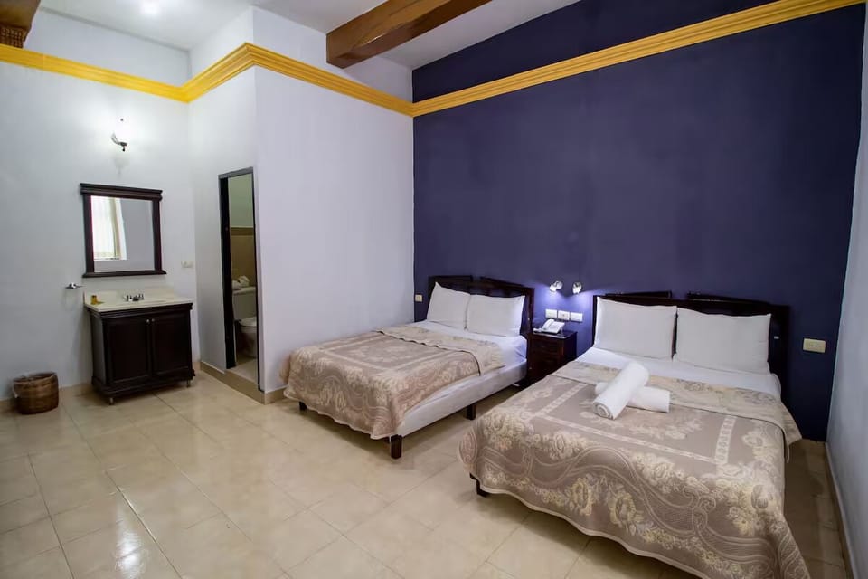 Share the room comfortably with two beds and airy high ceilings.
