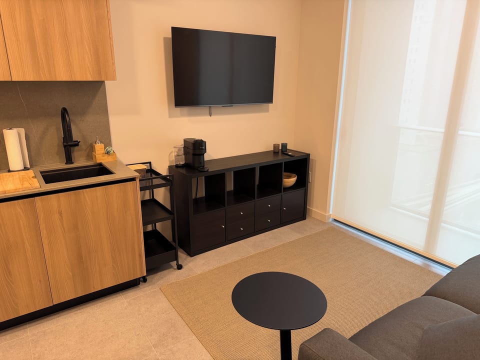 Smart Tv, Storage Cabinet and Nespresso Coffee maker. 