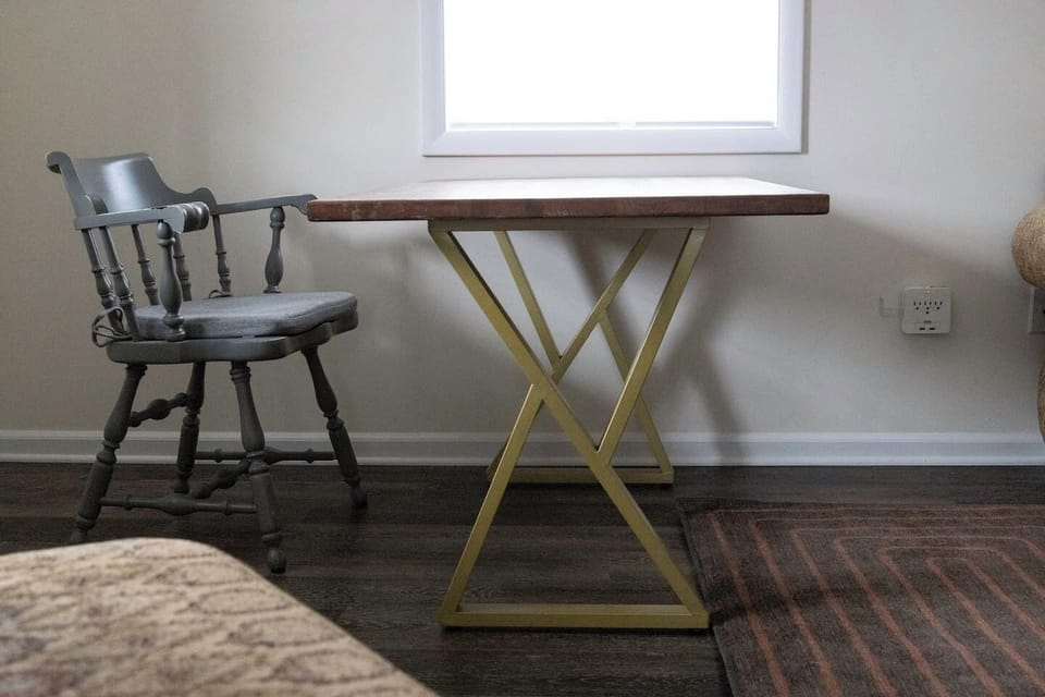 Living room features a refinished oak wood table with modern gold metal legs, perfectly positioned for working, watching TV, or socializing. 🪑✨📺