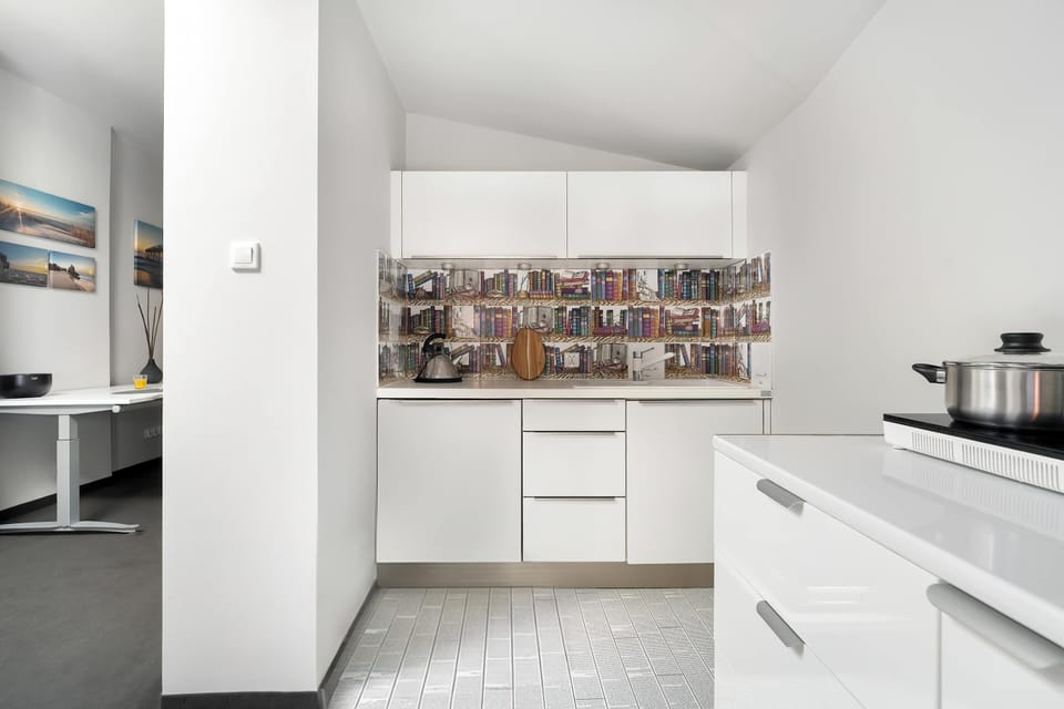 The kitchen with a dining table and breakfast setup. The space is open and functional for meals or working.