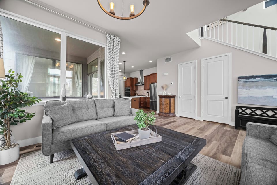 Bright, well-lit living room flowing seamlessly into the kitchen.