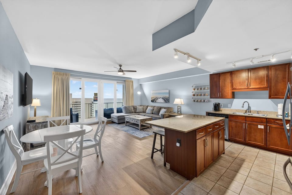 Relax in your spacious open-concept suite with modern kitchen, cozy living area, and stunning city views from your private balcony.