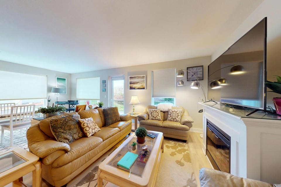 Spacious living room with plenty of seating and an open layout that connects to the kitchen.