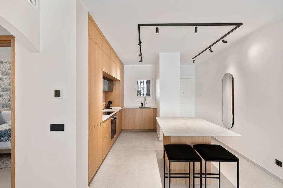 A spacious, modern kitchen with a kitchen island — the washer/dryer is neatly tucked inside the island for your convenience.