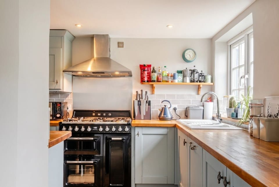 The Smeg range, butcher-block worktops, and open shelving make cooking a pleasure.