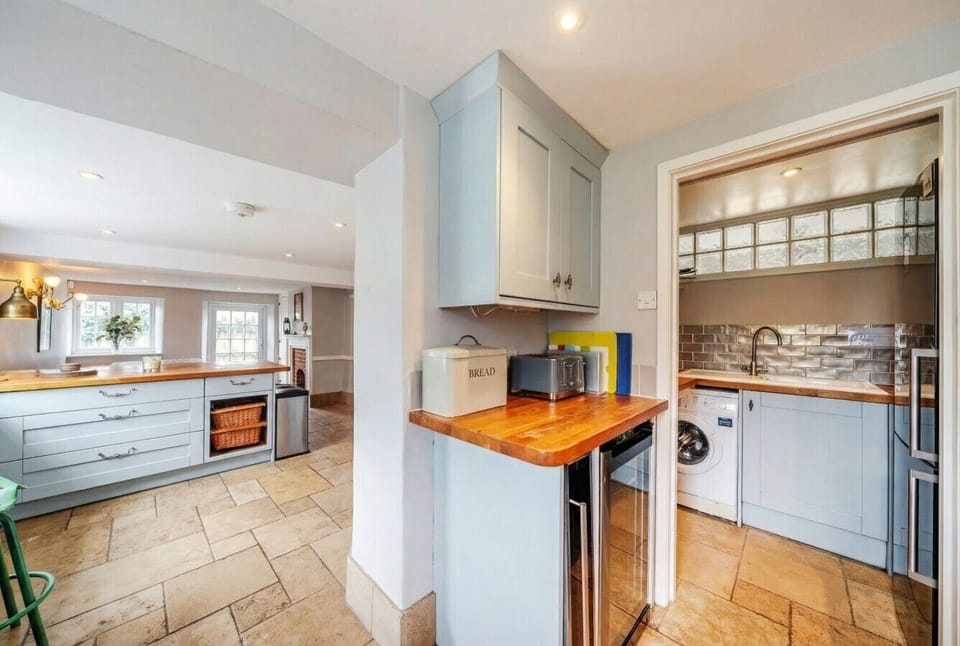 A generous kitchen island and adjoining utility room keep family stays running smoothly.