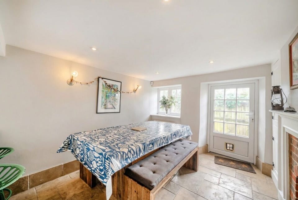 The dining room dressed for a relaxed meal with garden-door access to the outside.
