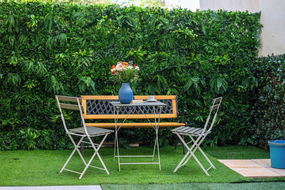Secluded Outdoor Seating Area Surrounded by Lush Greenery