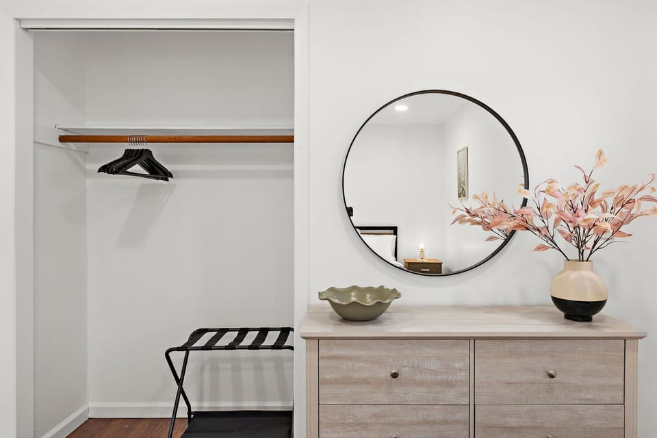 Bedroom 3: Spacious closet, full-length mirror, and a luggage rack — the thoughtful details that make longer stays easy.