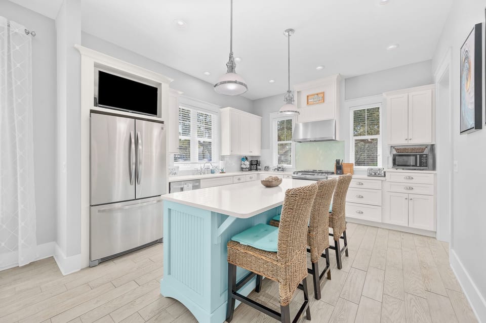 Bright kitchen with island seating and stainless appliances