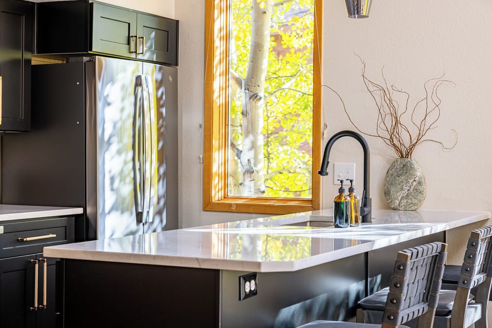 Cook with a Mountain View — Sunlight filters through aspen trees while you cook, snack, or pour a warm drink. Even kitchen moments feel special with the lake and mountains just outside your window.