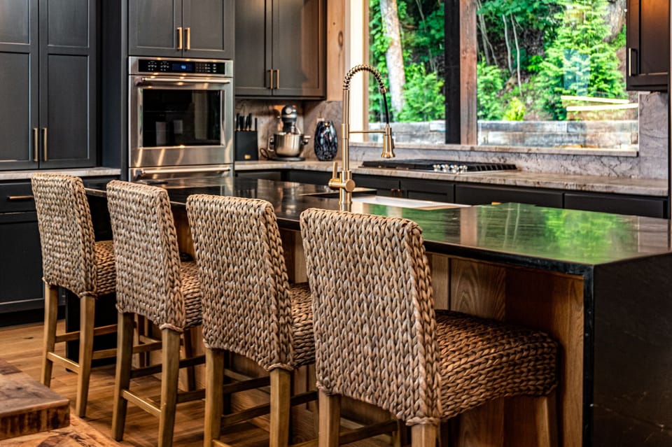 Gather at the kitchen island w/ bar seating, premium appliances, & large windows
