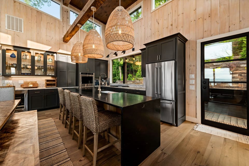 Gather in the chef’s kitchen w/ oversized island, bar seating, and double ovens.