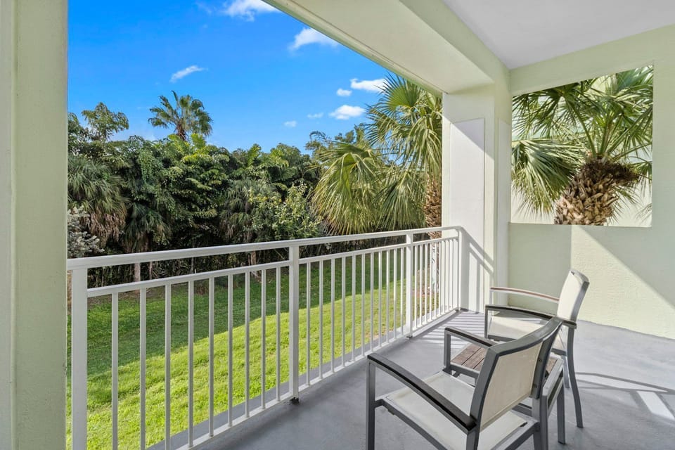 Private balcony with seating and lush garden views, perfect for enjoying fresh air and sunshine.