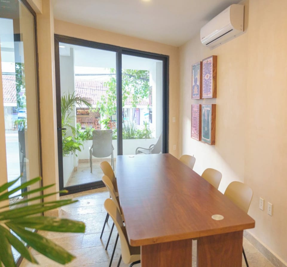 Gather for meals or remote work beside the sunny balcony.