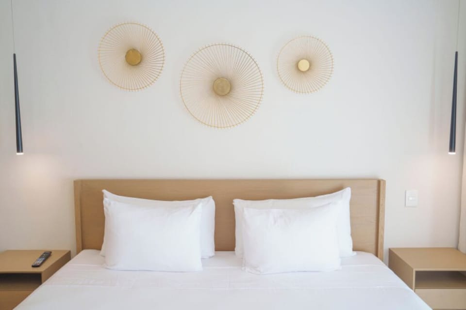 Sink into cloud-soft pillows beneath elegant, soothing wall décor.