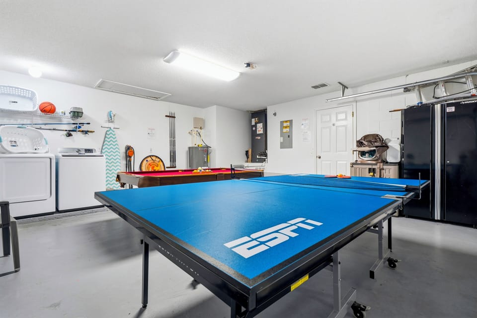 Fun game room with pool table, ping pong, and laundry area.