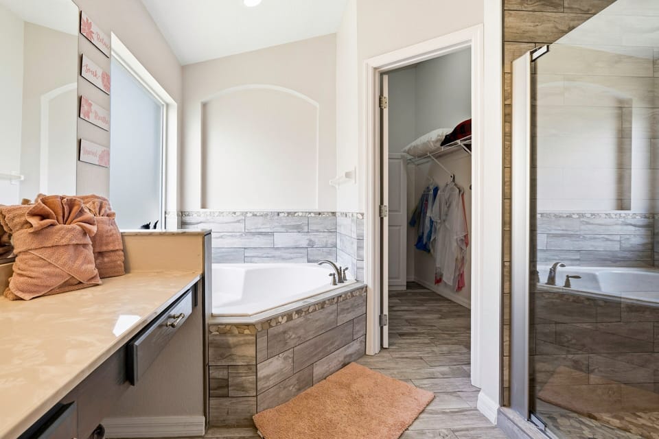 Spacious bathroom with double vanity, soaking tub, and walk-in shower.