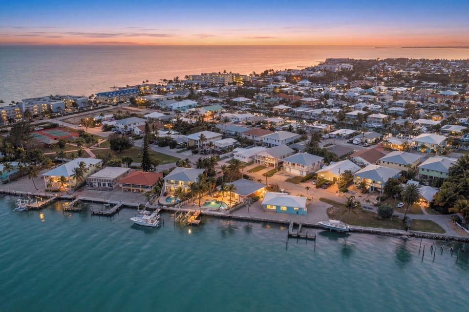 Experience breathtaking Florida Keys sunsets from the outdoor patio of this Marathon FL canal-front vacation rental with pool and tropical ambiance.