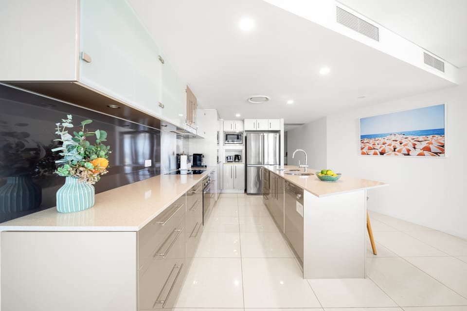Modern kitchen equipped with oven microwave coffee pod machine and ample storage