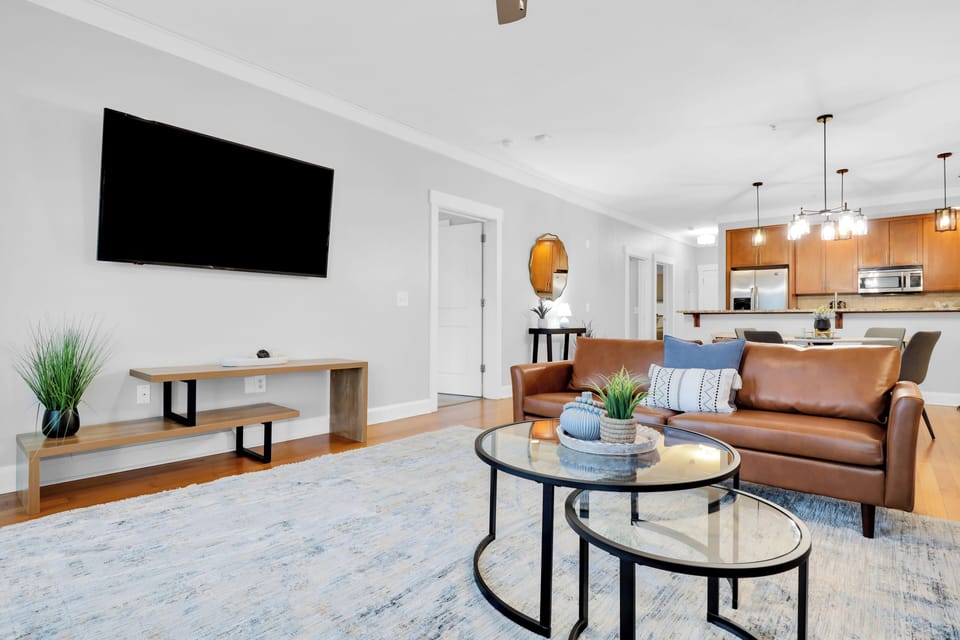 Bright, open-concept living area featuring modern design, warm finishes, and plenty of space to unwind. (Deluxe 2-Bedroom Unit)