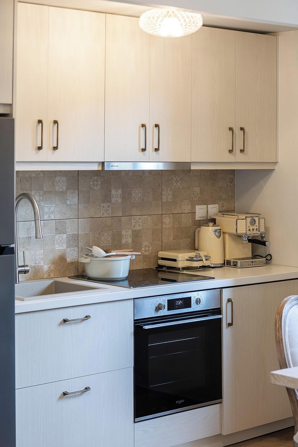 Main Building - The kitchen is equipped with modern appliances and a Whirlpool washer, ensuring a self-catered holiday