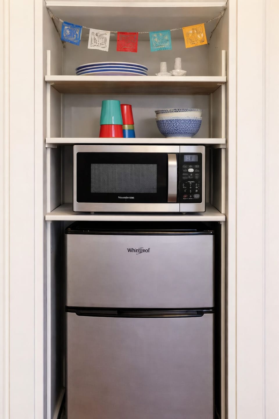 Microwave, mini fridge, and dishware