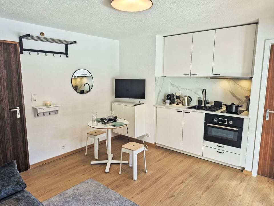 Furniture, Interior Design, Flooring, Floor, Wall, Room, Wood, Ceiling, Cabinetry, Apartment