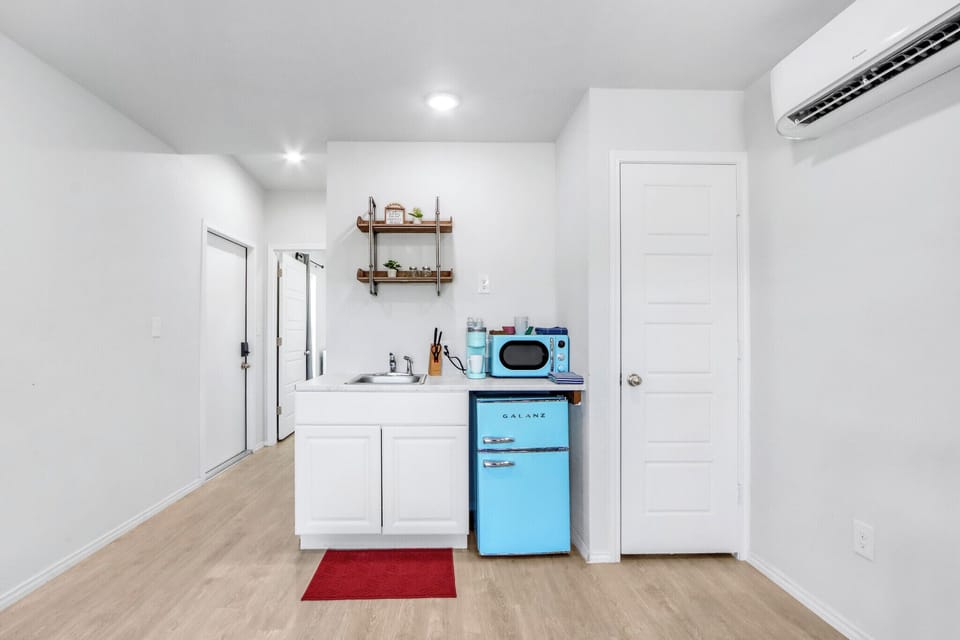 Kitchenette features a mini fridge and microwave