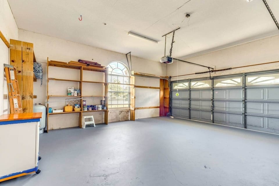 Spacious two-car garage with shelving—secure parking and gear storage