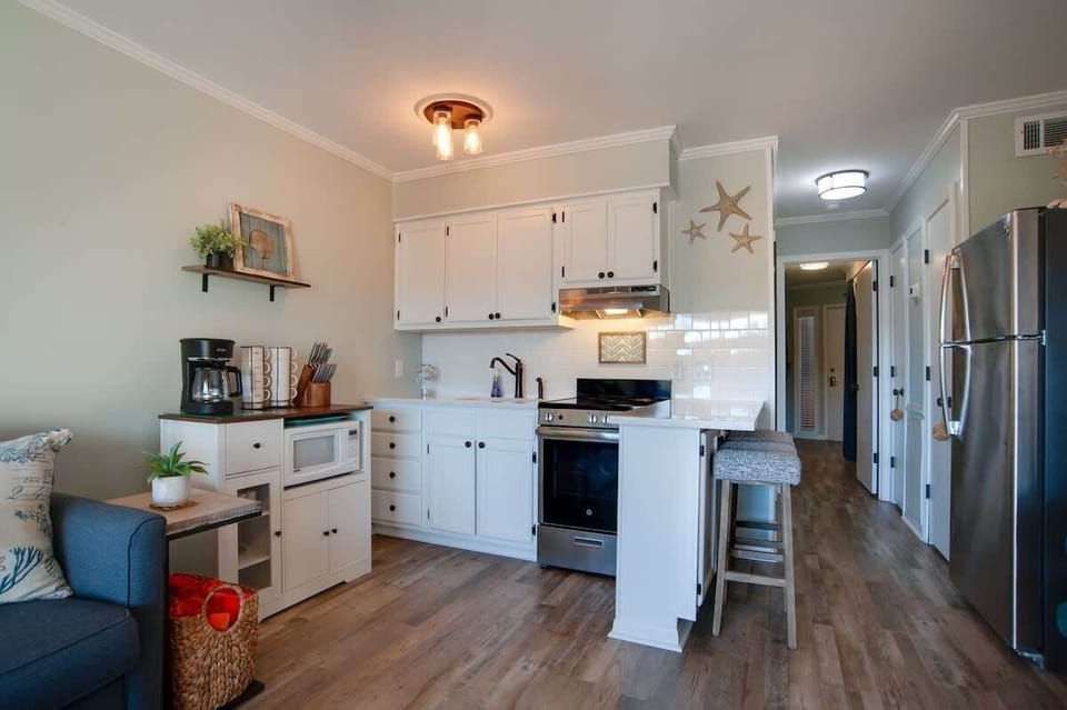 Your fully equipped kitchen features modern appliances and charming coastal touches, perfect for preparing meals during your stay.