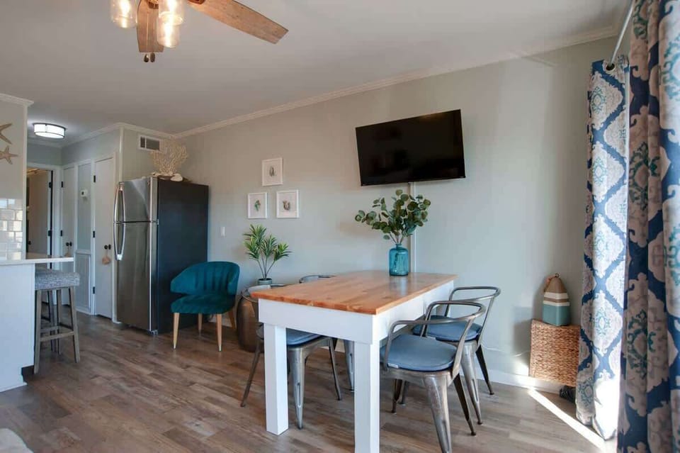 Gather around your stylish dining table for memorable meals in this beautifully furnished space with ocean-inspired touches.