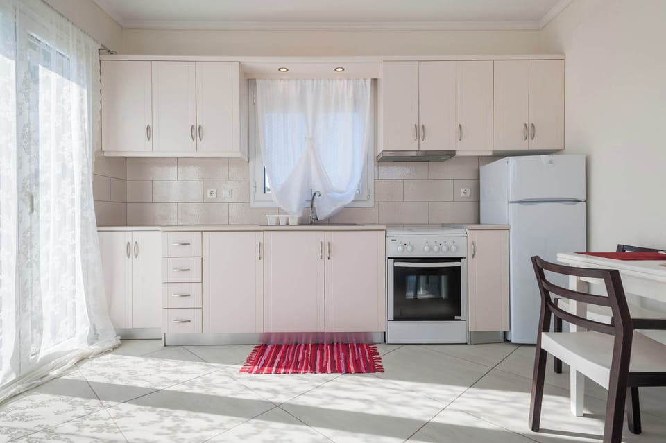 Spacious kitchen with dining table and modern appliances.