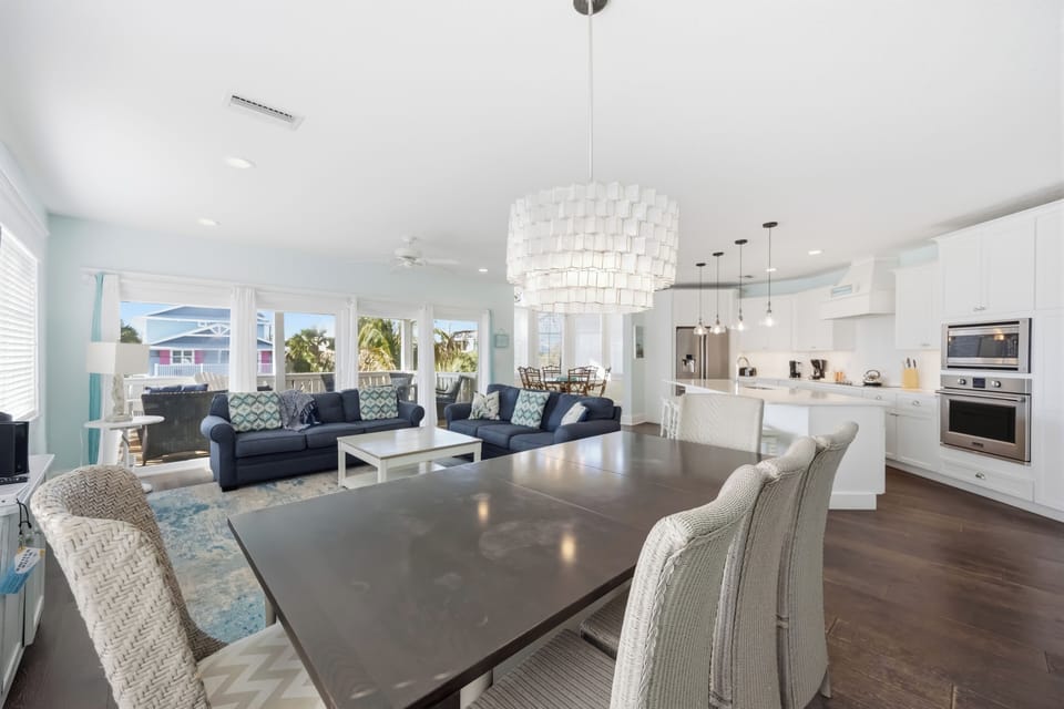 Relax in your open-concept living space where modern elegance meets tropical comfort, with designer lighting and stunning views.
