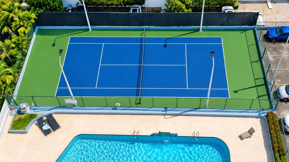 Enjoy a lit tennis court and sparkling resort-style pool