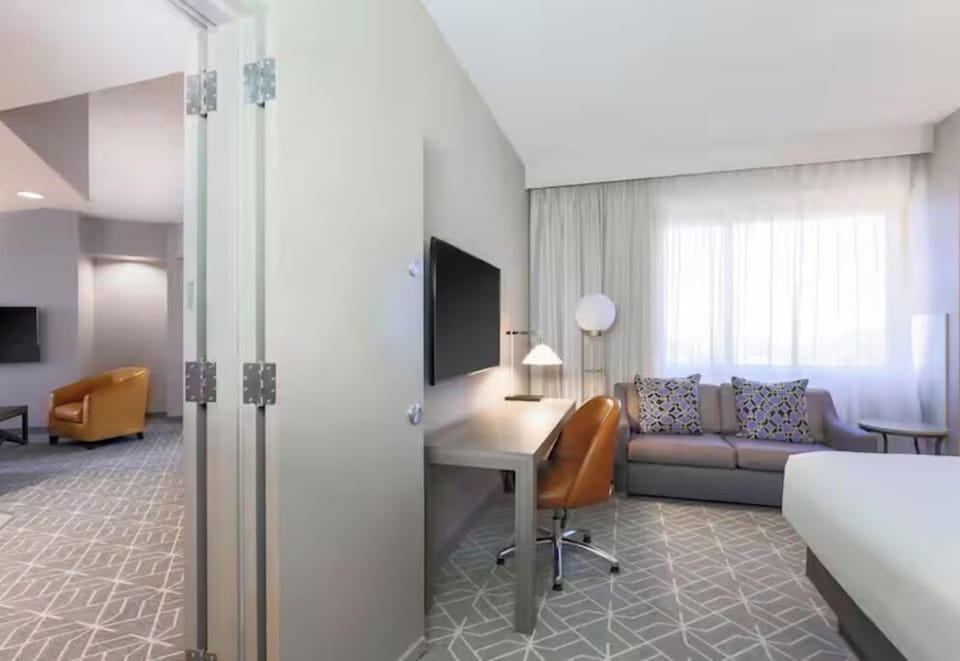 Step into an airy suite with distinct sleep and lounge zones.