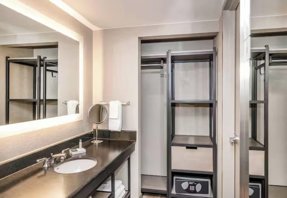 Settle in easily with open storage and in-room safe.