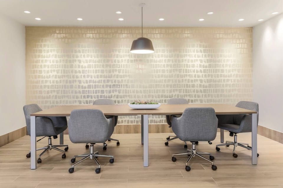 Gather comfortably around a spacious table for focused collaboration.