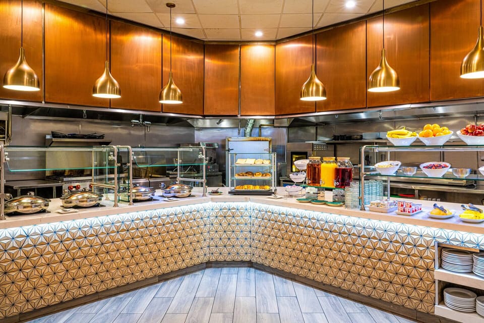 Start mornings with a generous buffet under warm pendant lights.