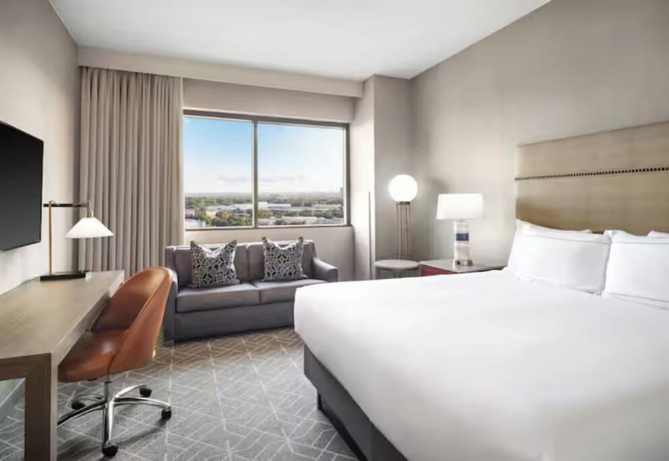 Unwind in a bright king room with skyline views.